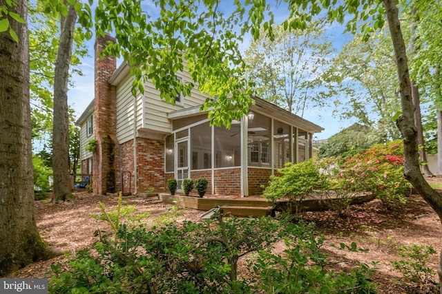 4303 S Valiant Ct, Annandale, VA 22003 - back of property with brick siding, a sunroom, and a chimney