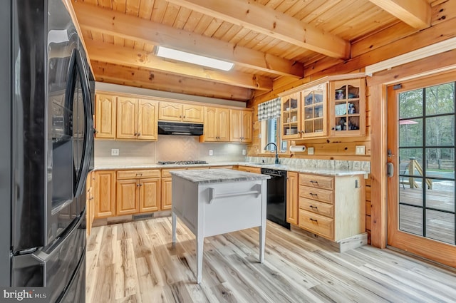 kitchen featuring light wood-style floors, dishwasher, beamed ceiling, and freestanding refrigerator
