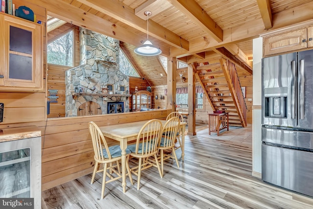 dining space with stairway, light wood-style floors, and wood ceiling