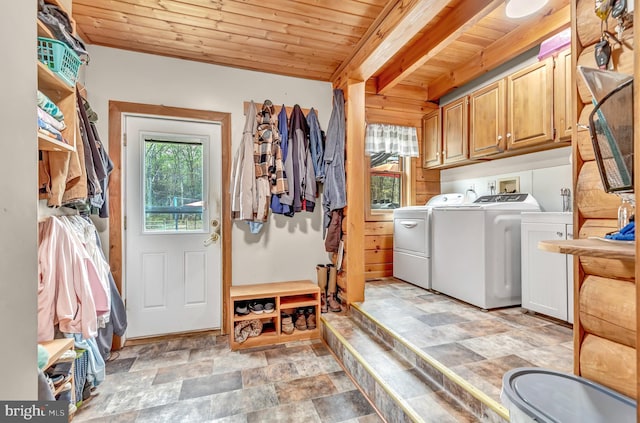 washroom with wooden ceiling, cabinet space, stone finish floor, and independent washer and dryer