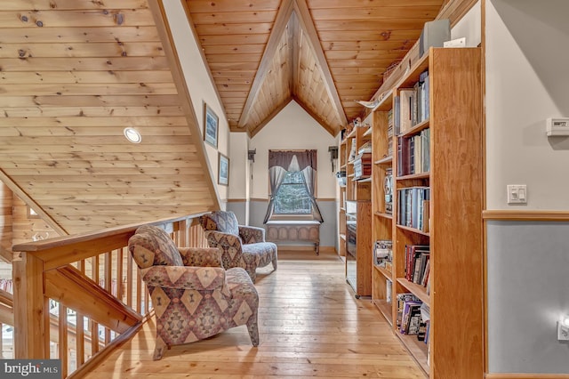 living area featuring hardwood / wood-style floors, wooden ceiling, and vaulted ceiling