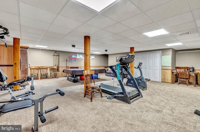workout area featuring carpet, visible vents, and a paneled ceiling