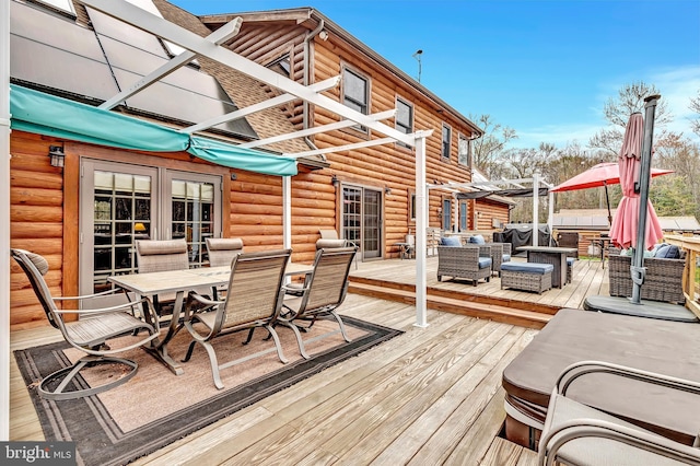 deck with a pergola, an outdoor living space, a jacuzzi, and outdoor dining area