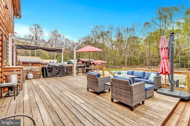 wooden deck featuring an outdoor living space, outdoor dining space, and area for grilling