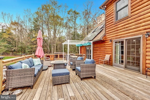 wooden deck with an outdoor living space with a fire pit