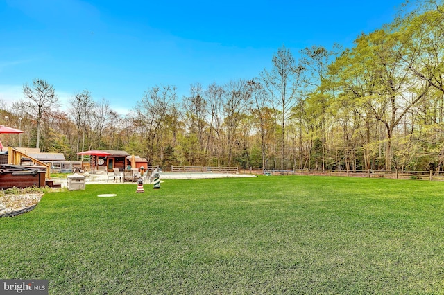 view of yard with fence and an outdoor structure