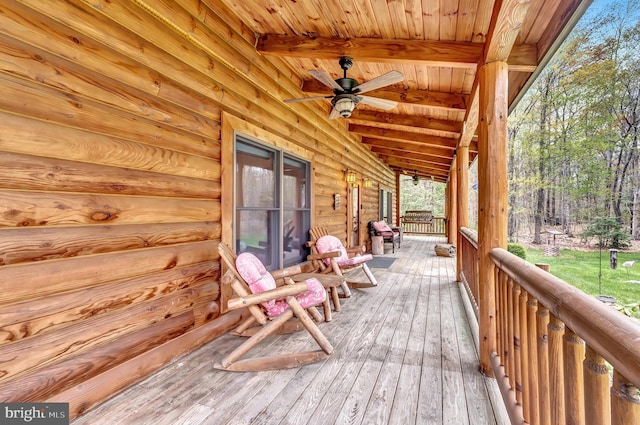wooden deck featuring ceiling fan