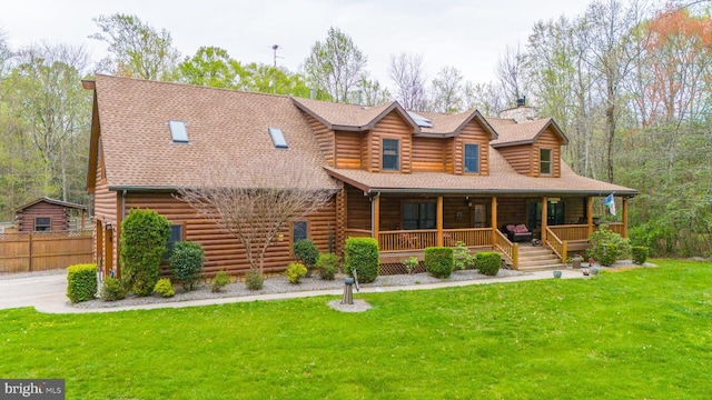 log-style house featuring a front yard, covered porch, a chimney, log exterior, and roof with shingles