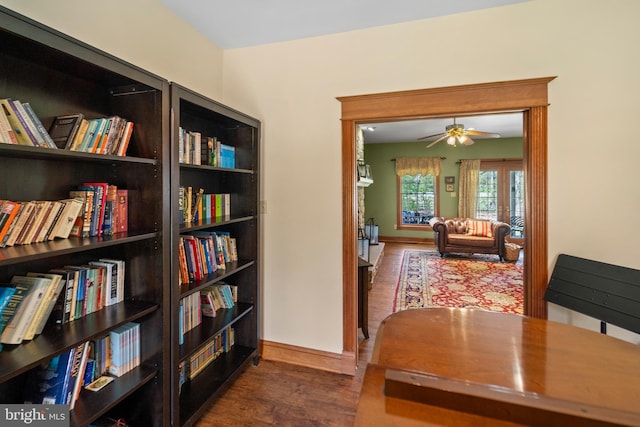 living area with wood finished floors and ceiling fan