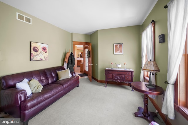 carpeted living area with visible vents and baseboards