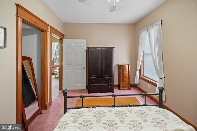 carpeted bedroom with baseboards and multiple windows