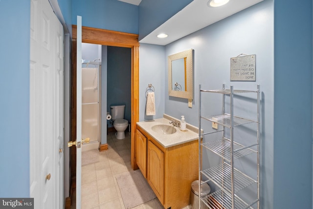 full bath featuring toilet, vanity, recessed lighting, and tile patterned floors