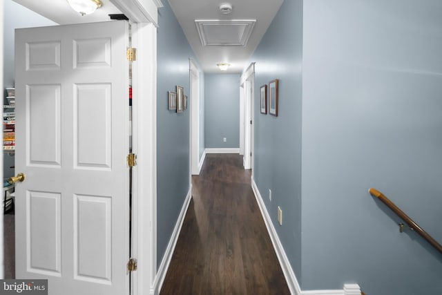 hallway with dark wood-style floors and baseboards