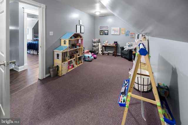 rec room featuring lofted ceiling and carpet flooring