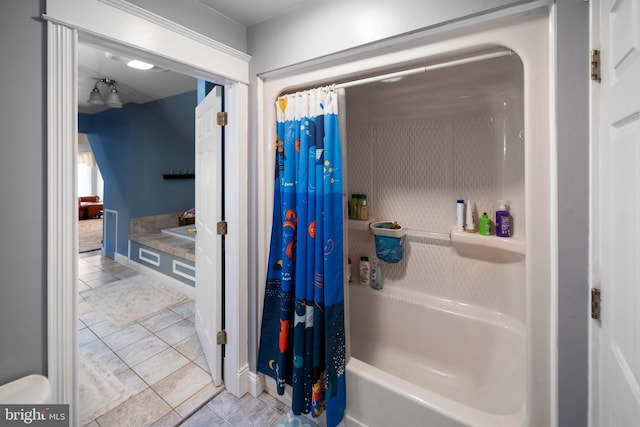 bathroom featuring tile patterned floors, shower / bathtub combination with curtain, and baseboards