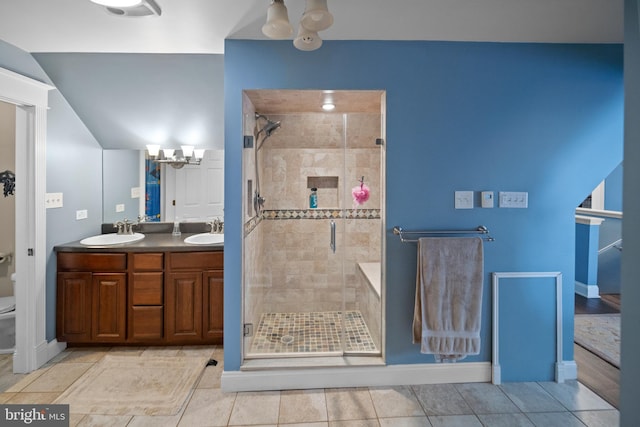 full bathroom with toilet, a sink, a shower stall, and a chandelier