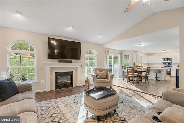 6815 Interlude Pl, Hughesville, MD 20637 - living area featuring light wood-type flooring, a ceiling fan, lofted ceiling, and plenty of natural light