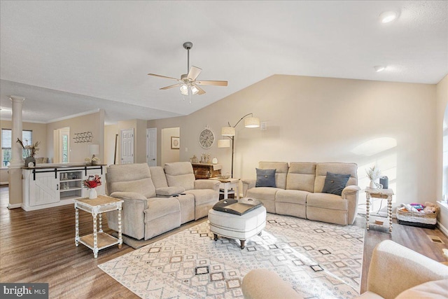 6815 Interlude Pl, Hughesville, MD 20637 - living room featuring ceiling fan, baseboards, vaulted ceiling, ornate columns, and wood finished floors