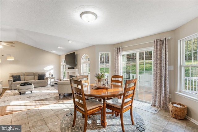 6815 Interlude Pl, Hughesville, MD 20637 - dining area with a fireplace, a ceiling fan, lofted ceiling, and baseboards