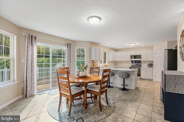 6815 Interlude Pl, Hughesville, MD 20637 - dining room featuring light tile patterned floors, a textured ceiling, and baseboards