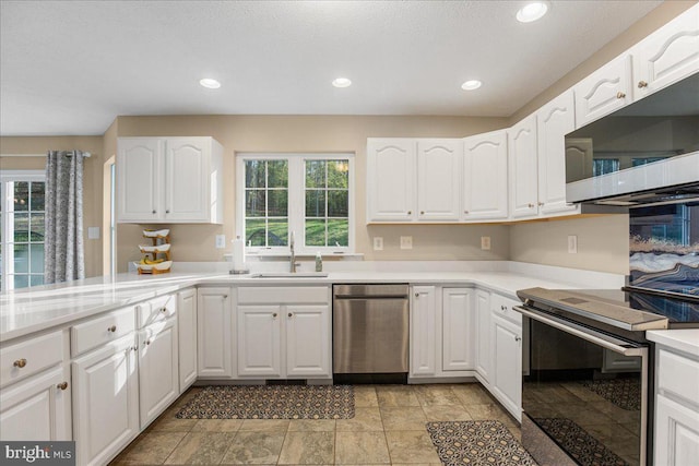 6815 Interlude Pl, Hughesville, MD 20637 - kitchen with recessed lighting, a sink, white cabinetry, light countertops, and appliances with stainless steel finishes