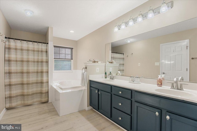 6815 Interlude Pl, Hughesville, MD 20637 - bathroom with wood finished floors, a garden tub, double vanity, and a sink