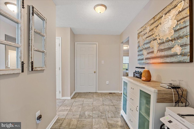 6815 Interlude Pl, Hughesville, MD 20637 - interior space with a textured ceiling, a bar, and baseboards