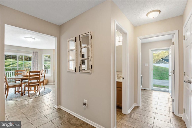 6815 Interlude Pl, Hughesville, MD 20637 - hall with light tile patterned flooring, a healthy amount of sunlight, and baseboards