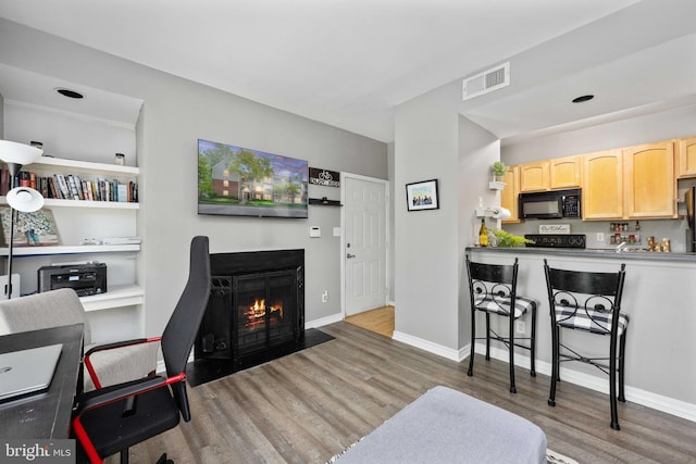 12152 Penderview Ter Unit 1322, Fairfax, VA 22033 - interior space with a fireplace with flush hearth, baseboards, wood finished floors, and visible vents