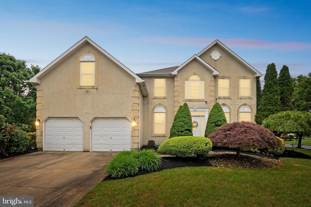 2 Rosebush Ct, Sicklerville, NJ 08081 - view of front of house with driveway, a garage, and stucco siding
