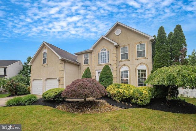 2 Rosebush Ct, Sicklerville, NJ 08081 - view of front of house with an attached garage, stucco siding, concrete driveway, and a front lawn