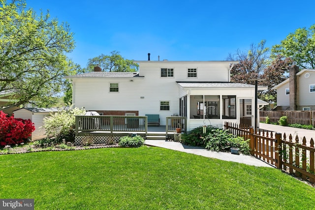 5311 Crestedge Ln, Rockville, MD 20853 - back of property featuring a sunroom, a deck, a chimney, and roof with shingles
