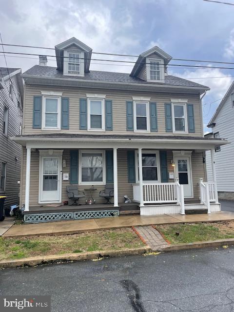 townhome / multi-family property featuring a porch