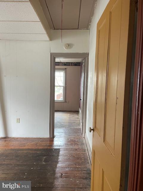 hall with wood-type flooring and attic access