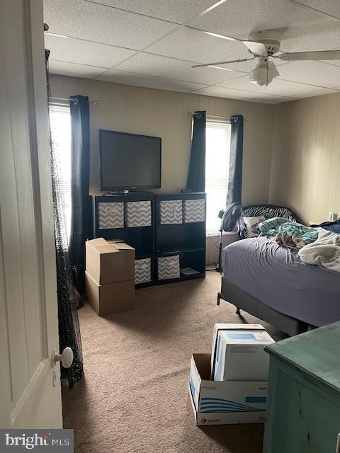 bedroom with ceiling fan and carpet flooring