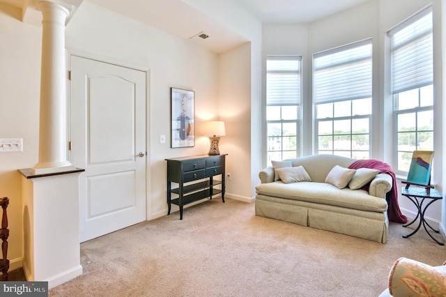 sitting room featuring baseboards, decorative columns, carpet flooring, and visible vents
