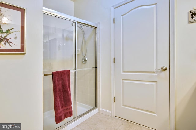 full bathroom with tile patterned floors and a shower stall