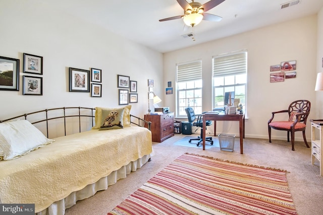 bedroom featuring baseboards, visible vents, light carpet, and ceiling fan