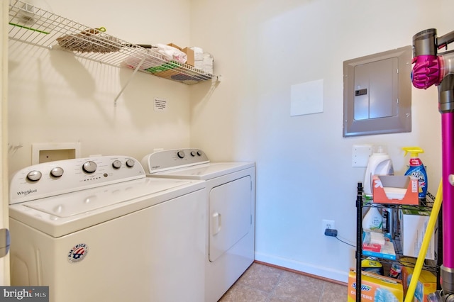 washroom with laundry area, baseboards, washer and clothes dryer, electric panel, and light tile patterned floors