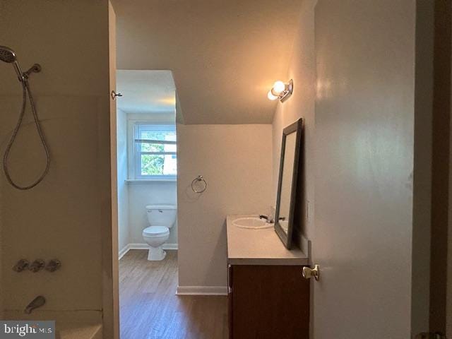 full bathroom with vanity, baseboards, toilet, and wood finished floors