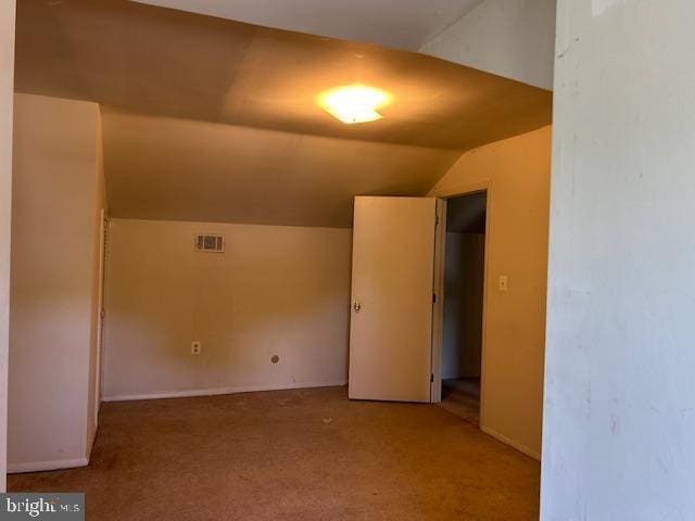 bonus room featuring carpet floors, baseboards, lofted ceiling, and visible vents