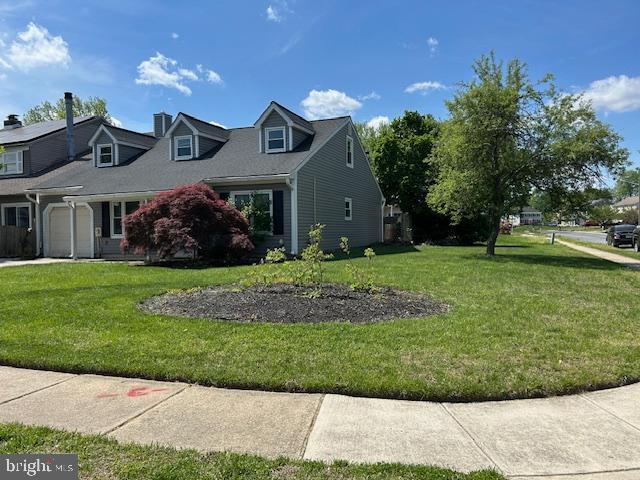 view of home's exterior featuring a lawn, a chimney, and a garage