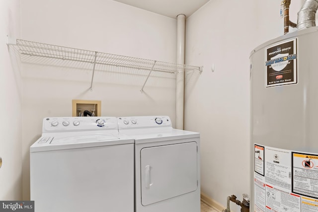 laundry area with laundry area, washer and clothes dryer, and gas water heater