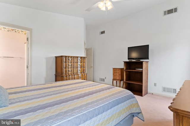 carpeted bedroom featuring a ceiling fan and visible vents