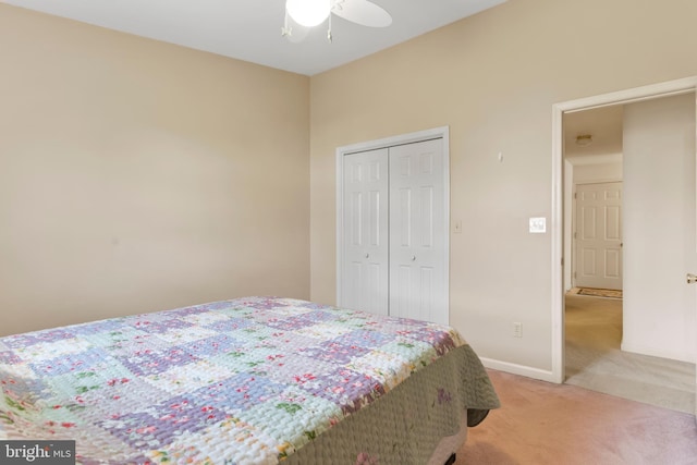 bedroom with a ceiling fan, baseboards, light colored carpet, and a closet