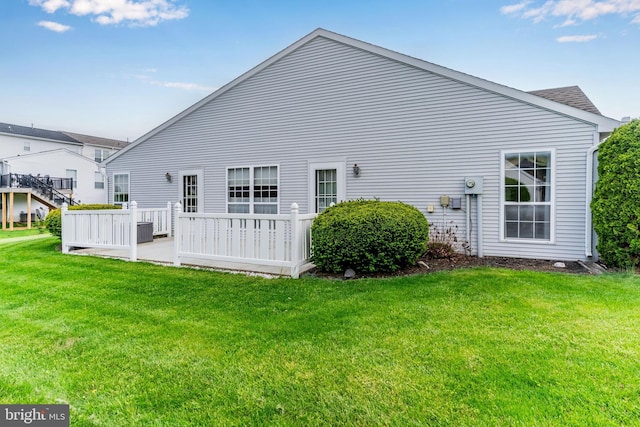 back of property featuring a yard