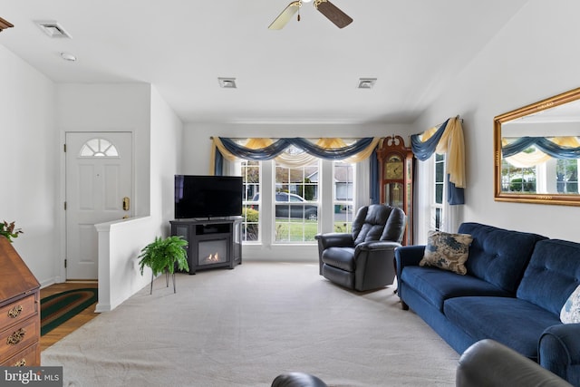 living area with visible vents and a ceiling fan