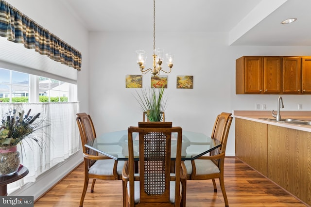 dining space featuring a notable chandelier and light wood-style flooring