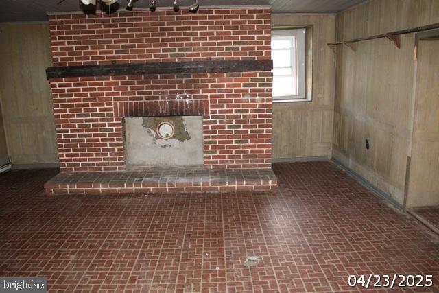 9635 Upper Strasburg Rd, Upperstrasburg, PA 17265 - room details with wood walls and a fireplace