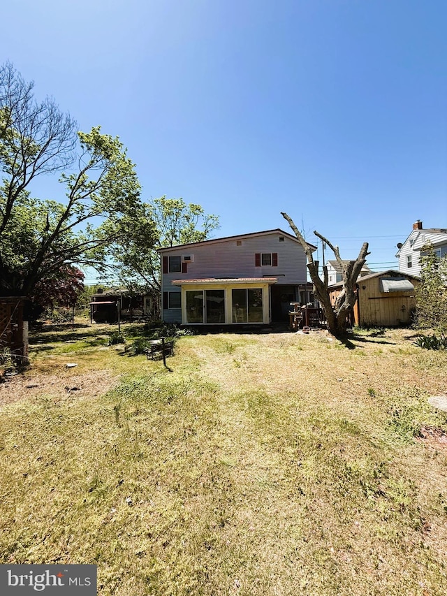 377 Main St, Cedarville, NJ 08311 - back of property with a lawn, an outdoor structure, and a sunroom